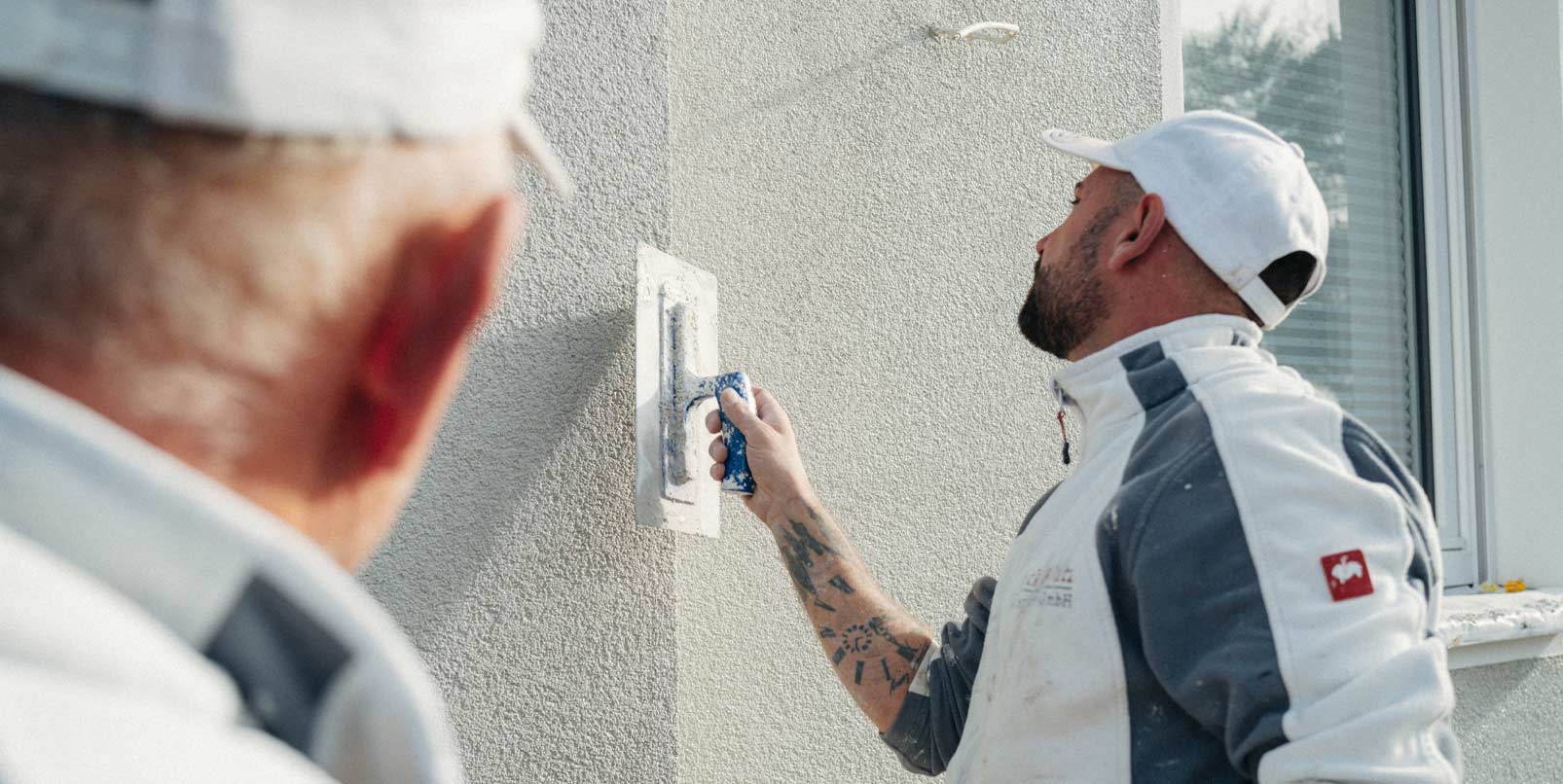 Stuckateurmeister Sven Holterhöfer verputzt eine Außenwand